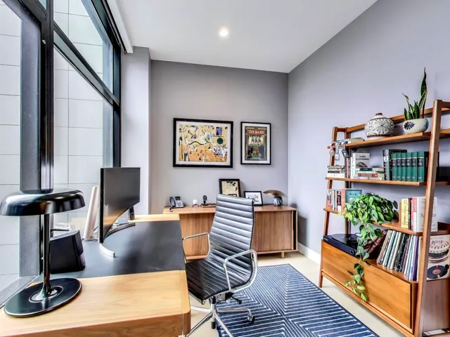 a work room with furniture lamp and rug