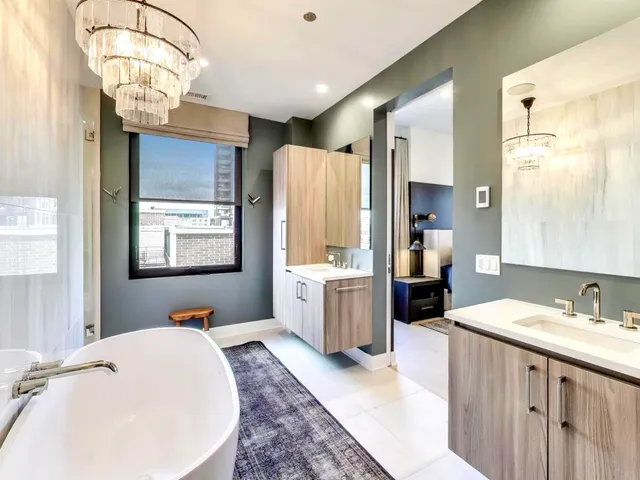 a bathroom with a tub sink and mirror