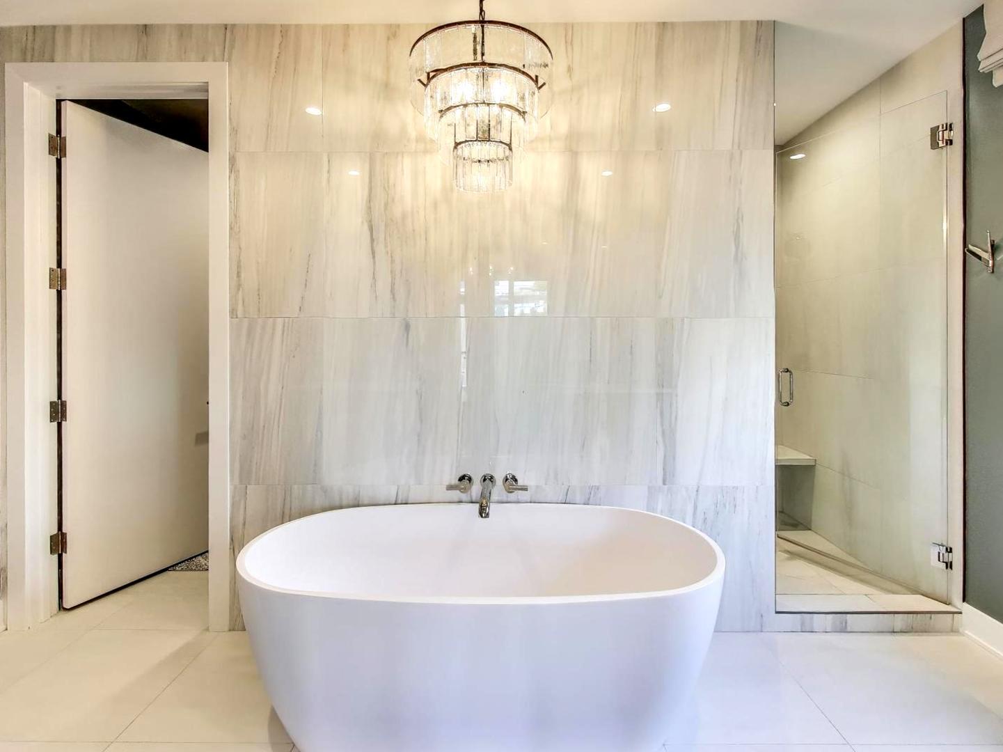 6 North Carpenter Street, Unit 5B Chicago, IL 60607 - Photo 17 of 40 a white bath tub sitting in a bathroom