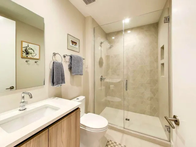 a bathroom with a sink toilet and shower