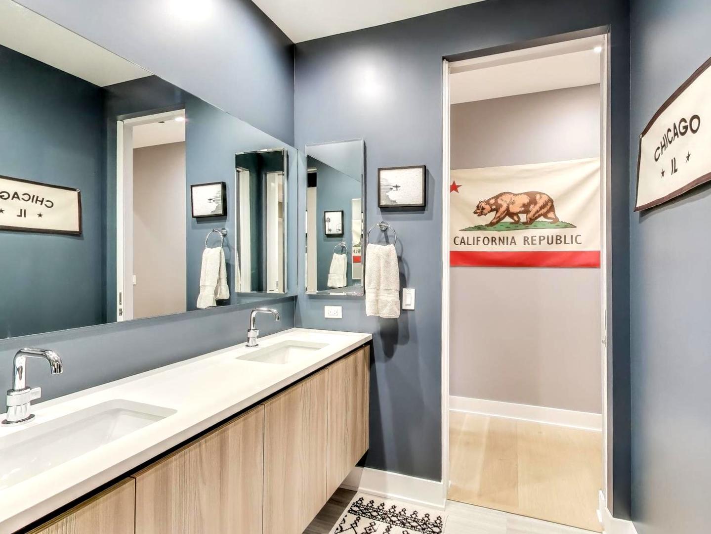 6 North Carpenter Street, Unit 5B Chicago, IL 60607 - Photo 23 of 40 a bathroom with a sink a mirror and a shower