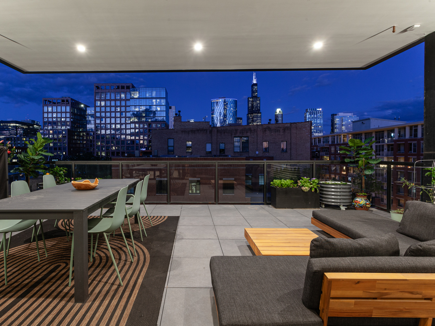 6 North Carpenter Street, Unit 5B Chicago, IL 60607 - Photo 30 of 40 a living room with furniture a rug and a potted plant