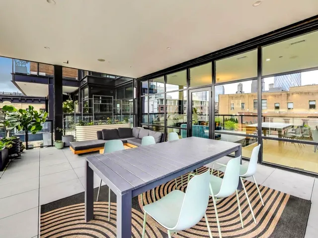 a dining room with a table and chairs