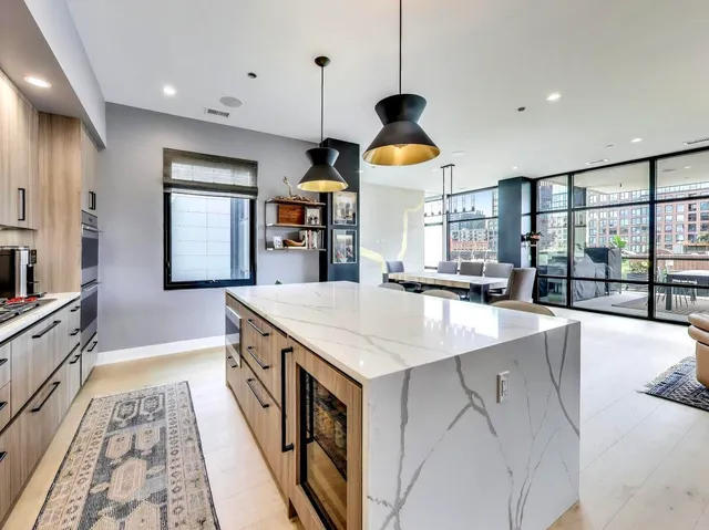 a open kitchen with stainless steel appliances granite countertop a sink a stove and a wooden floors