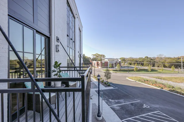 a view of a balcony with ocean view and wooden floor