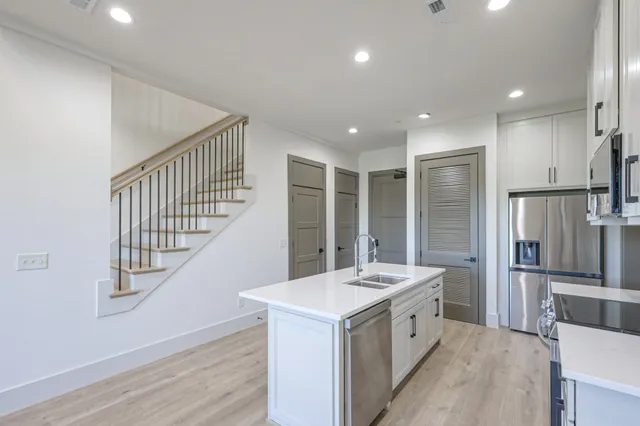 a kitchen with a sink and a refrigerator