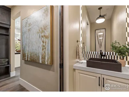 a view of a hallway with wooden floor and windows