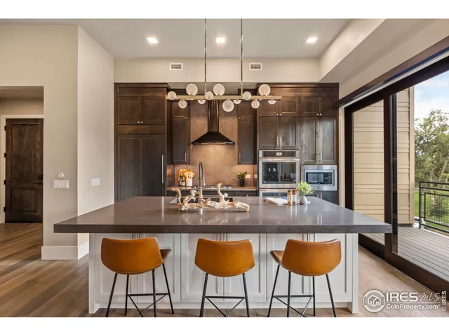 a kitchen with granite countertop a table chairs stove and kitchen view