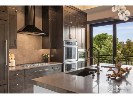 a living room with stainless steel appliances kitchen island granite countertop a refrigerator and a stove