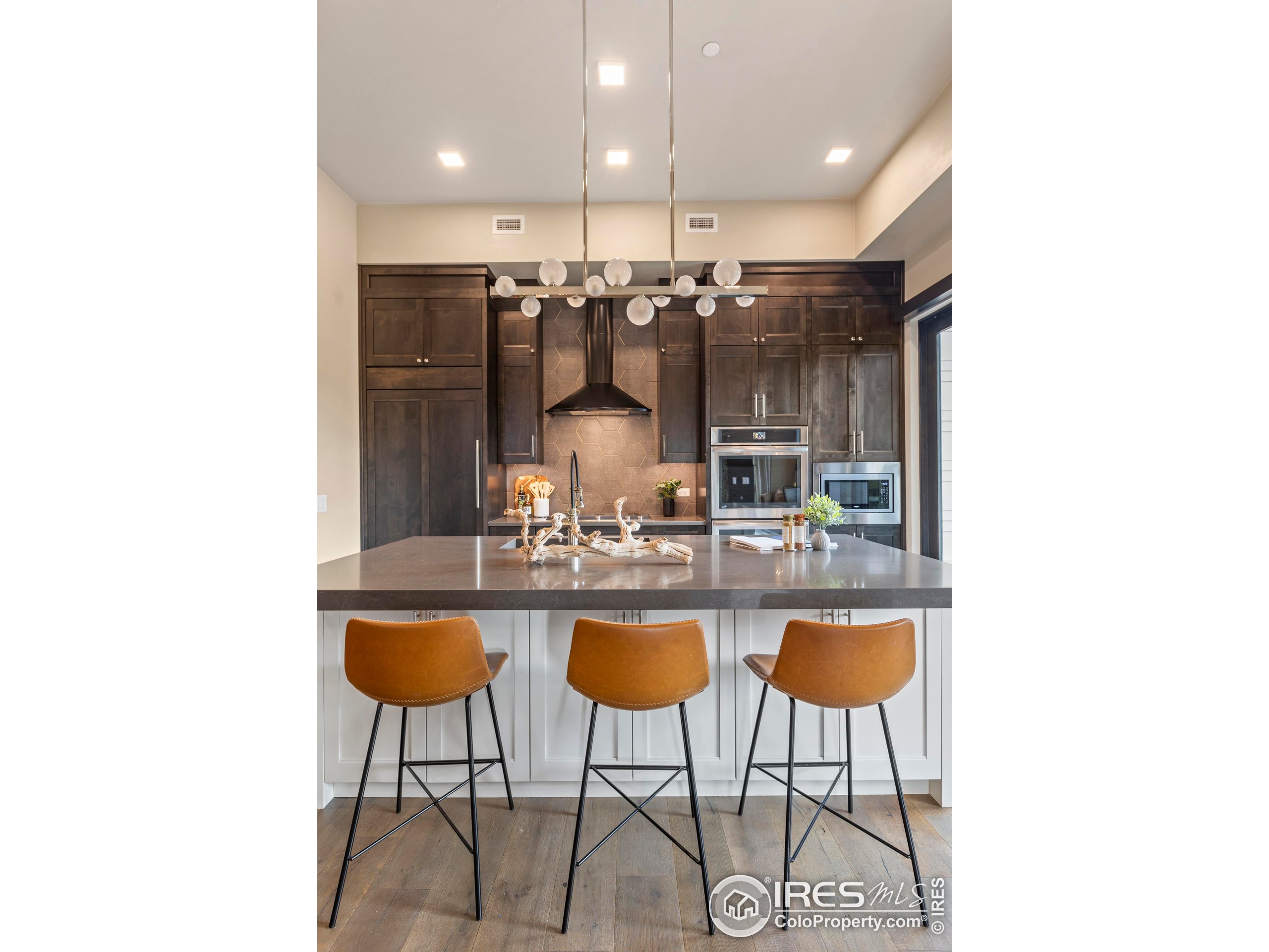 302 North Meldrum Street, Unit 314 Fort Collins, CO 80521 - Photo 28 of 50 a kitchen with a sink and chairs