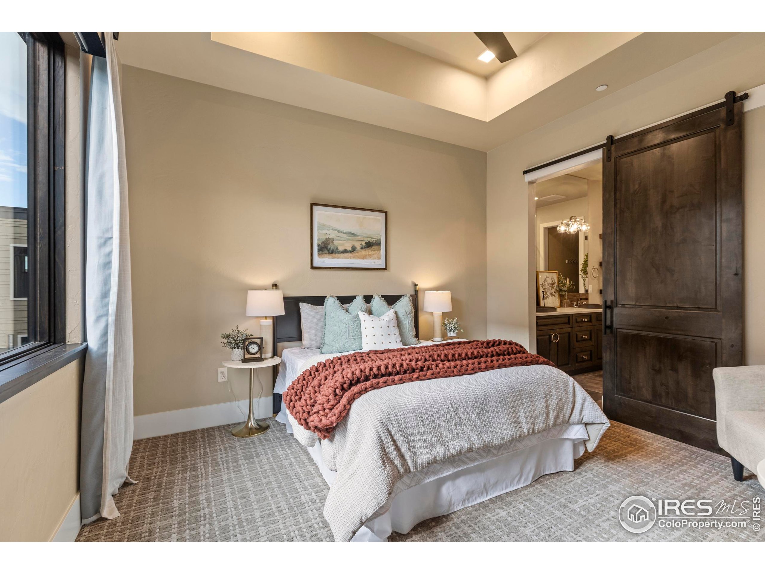 302 North Meldrum Street, Unit 314 Fort Collins, CO 80521 - Photo 29 of 50 a bedroom with a bed and a view of kitchen
