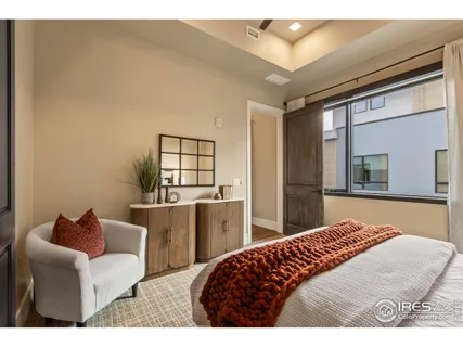 a bedroom with a bed and glass windows