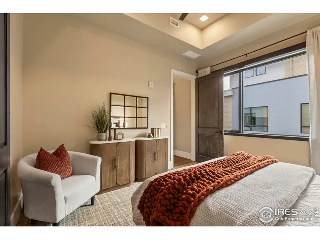 a bedroom with a bed and glass windows