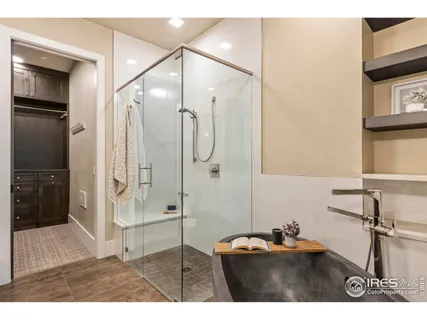 a bathroom with a sink mirror and shower