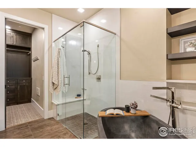 a bathroom with a sink mirror and shower