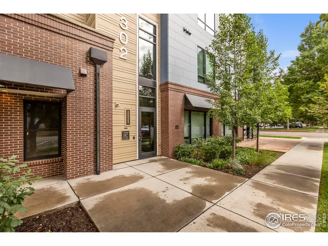 a view of a brick house with a yard
