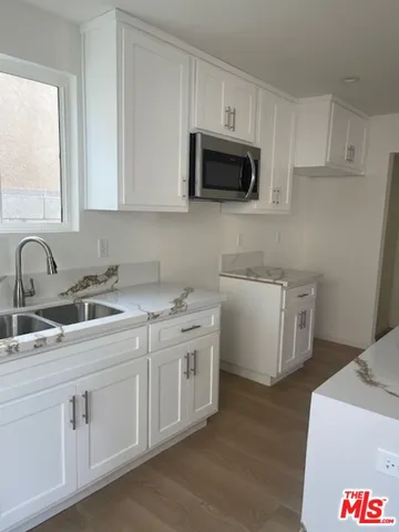 a kitchen with a sink stove and microwave