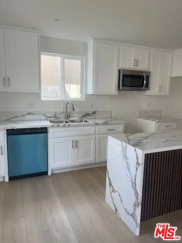 a kitchen with a sink stove and cabinets
