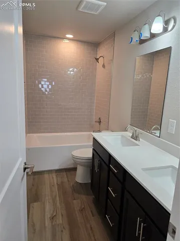 a bathroom with a bathtub a sink and a large mirror