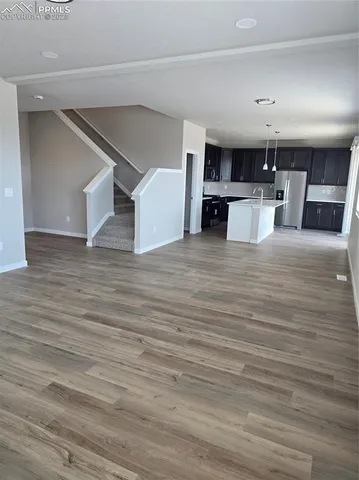 a view of a kitchen with a dishwasher kitchen cabinets and wooden floor