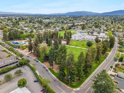 an aerial view of a residential houses with outdoor space