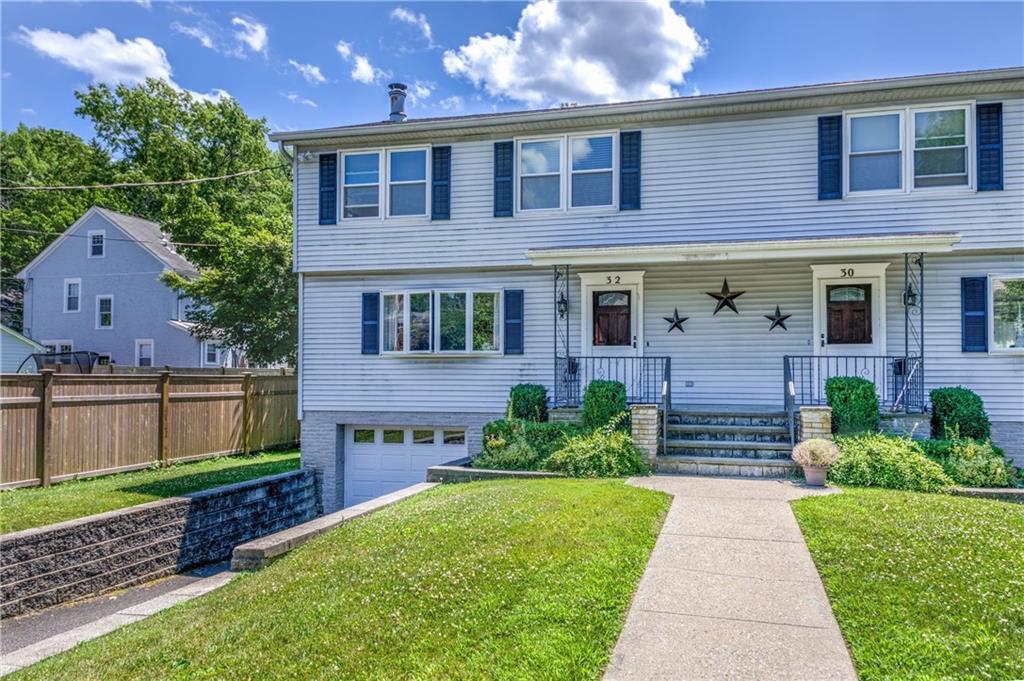 a front view of a house with a garden and plants