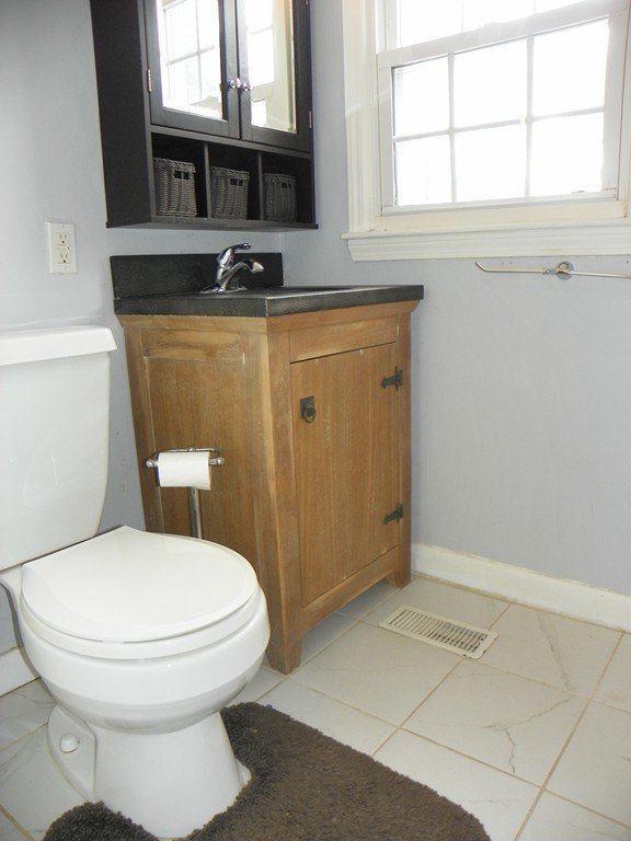3 Elm Street, Unit 1 Acton, MA 01720 - Photo 11 of 12 a bathroom with a toilet a sink and a window