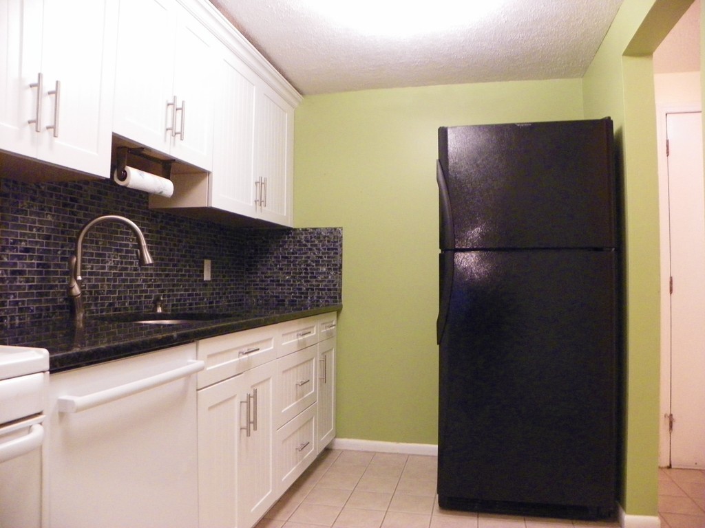 3 Elm Street, Unit 1 Acton, MA 01720 - Photo 2 of 12 a kitchen with a refrigerator and a sink