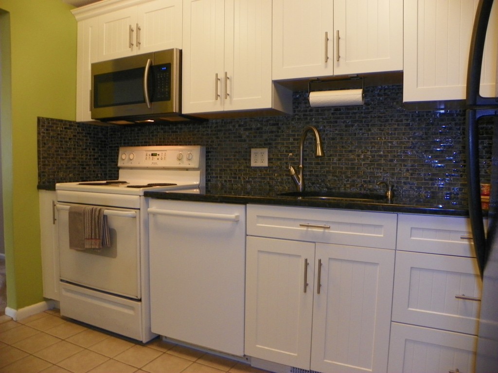 3 Elm Street, Unit 1 Acton, MA 01720 - Photo 3 of 12 a kitchen with cabinets stainless steel appliances and a sink