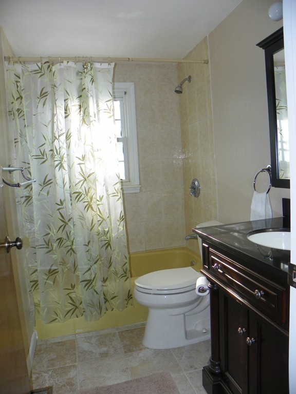 3 Elm Street, Unit 1 Acton, MA 01720 - Photo 9 of 12 a bathroom with a granite countertop sink toilet and shower