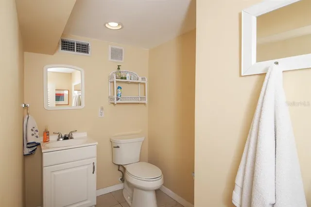 a bathroom with a sink toilet and a mirror