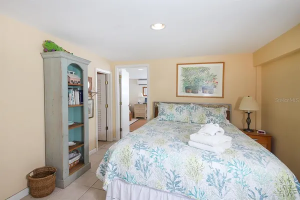 a bedroom with a bed and a painting on the wall