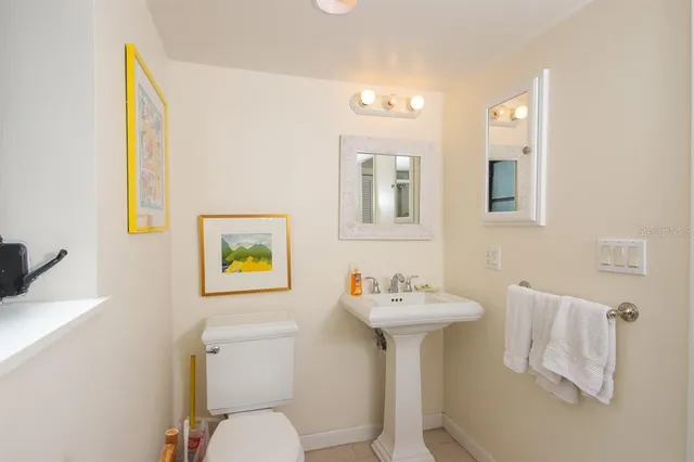 a bathroom with a sink mirror and toilet