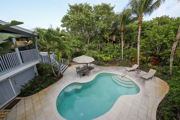 a view of a swimming pool with sitting area