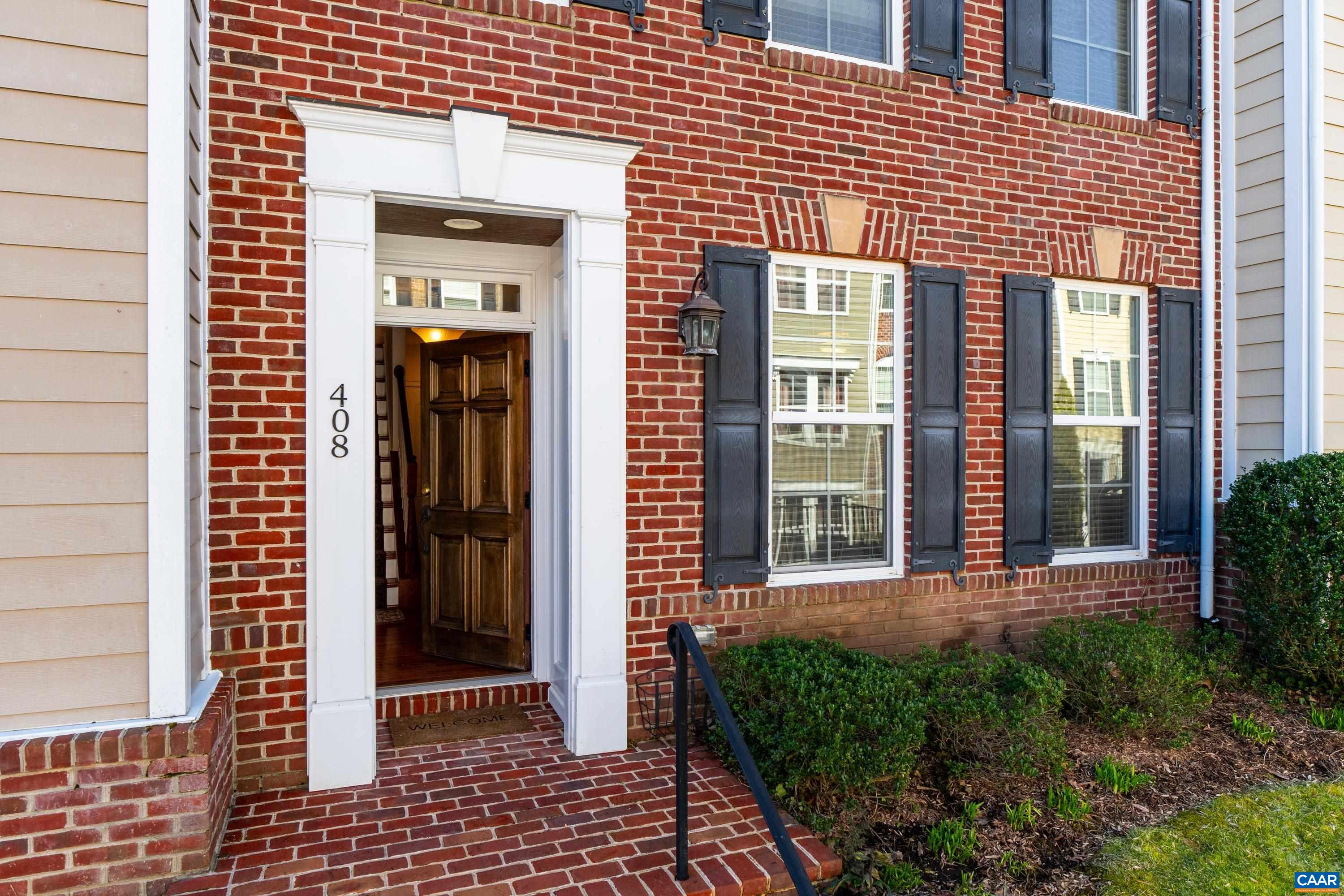 408 Samara Court Charlottesville, VA 22903 - Photo 5 of 44 a view of a brick house with large windows