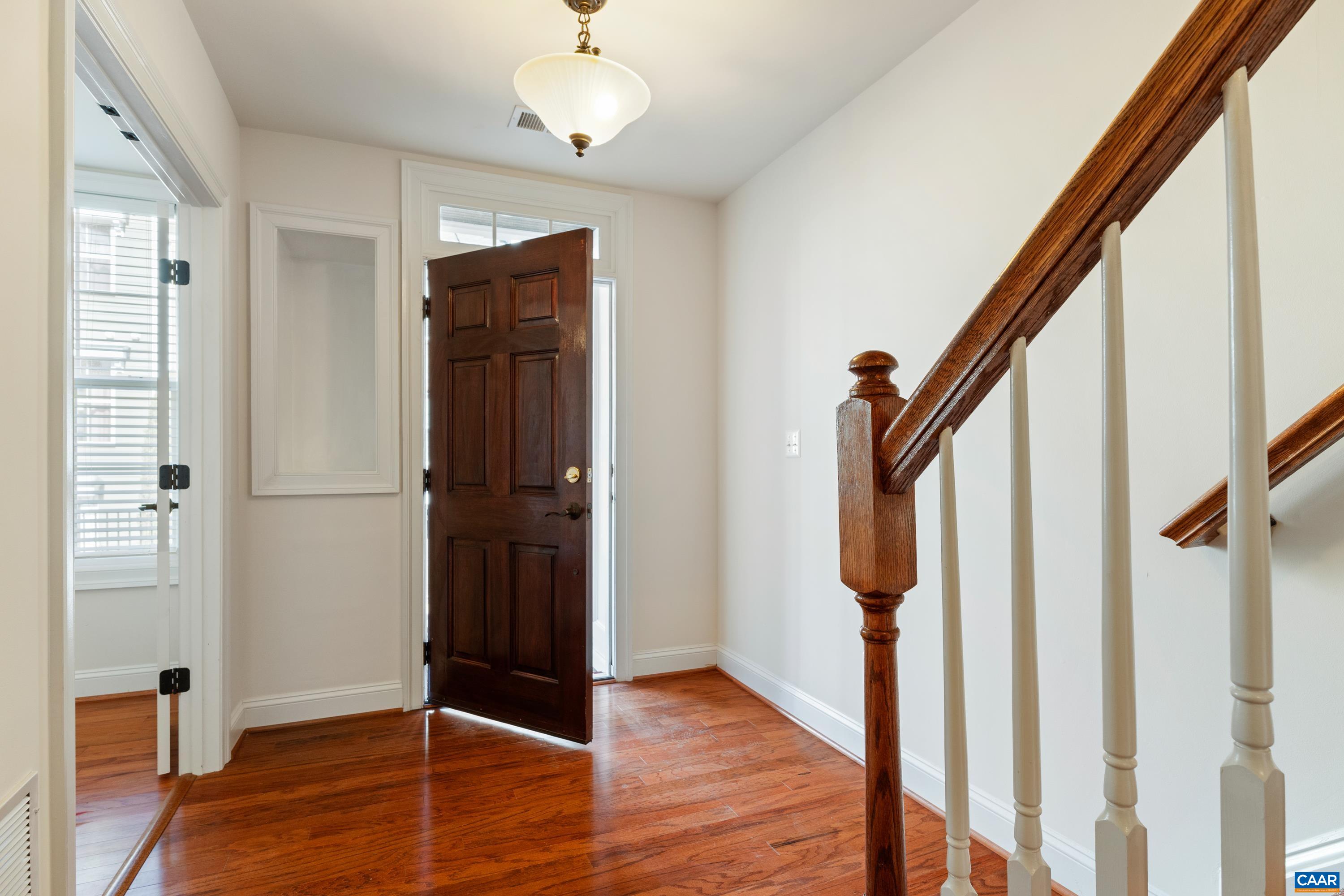 408 Samara Court Charlottesville, VA 22903 - Photo 7 of 44 a view of an entryway with wooden floor and stair