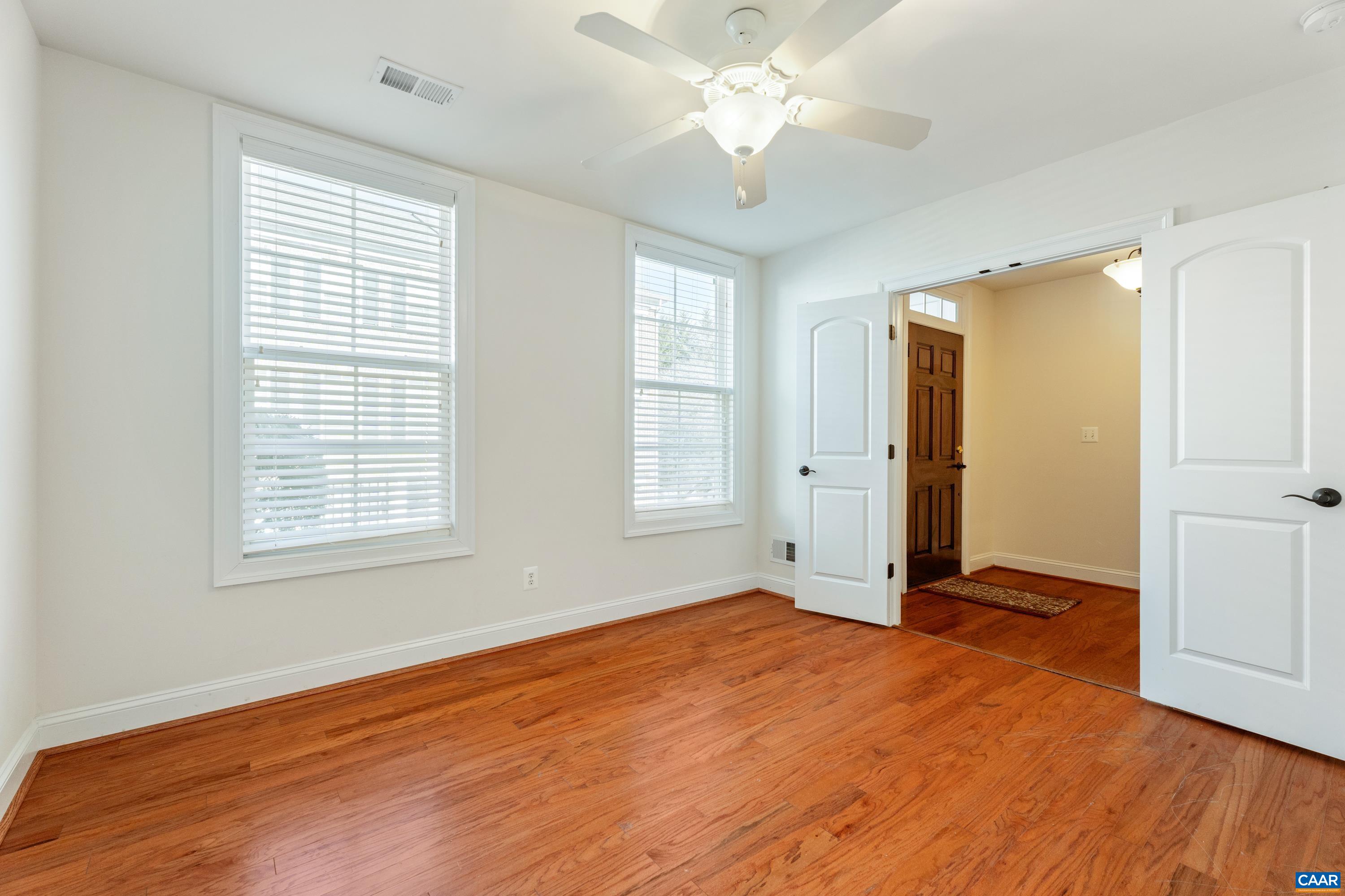 408 Samara Court Charlottesville, VA 22903 - Photo 10 of 44 a view of an empty room with wooden floor and a window
