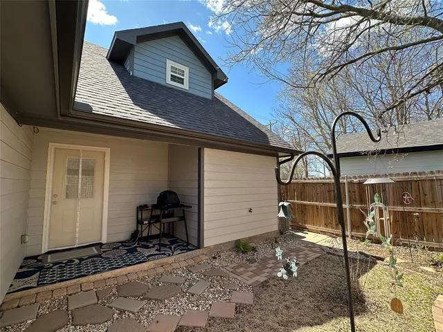 a view of a house with a big yard and a large trees