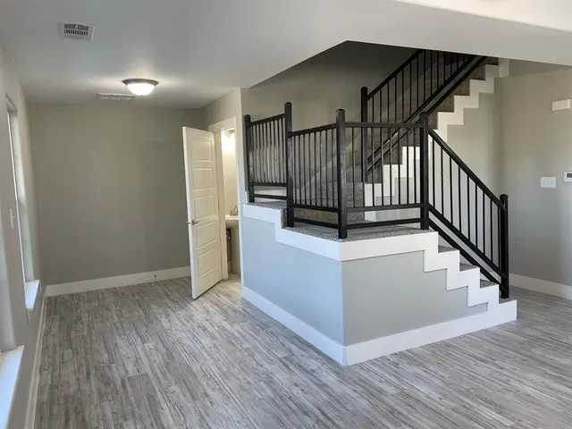 a view of entryway with wooden floor and stairs