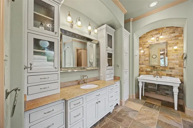 a spacious bathroom with double vanity and a mirror