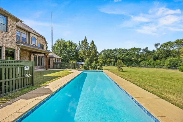 a view of a swimming pool with a yard