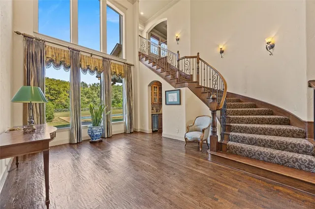 a view of entryway with wooden floor and front door