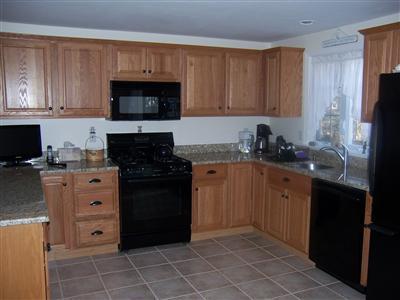 78 Richardson Road Centerville, MA 02632 - Photo 5 of 20 a kitchen with cabinets appliances and a sink