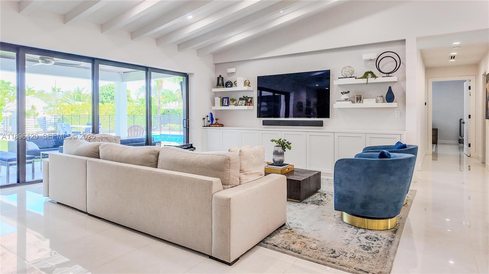 12855 Maple Road North Miami, FL 33181 - Photo 13 of 51 a living room with furniture and a large window