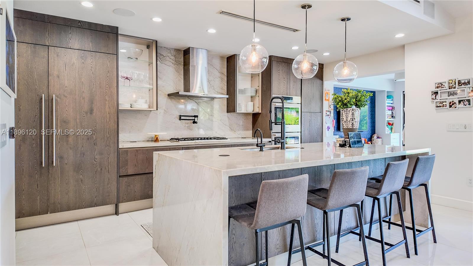 12855 Maple Road North Miami, FL 33181 - Photo 17 of 51 a kitchen with kitchen island granite countertop a sink a center island stainless steel appliances and cabinets