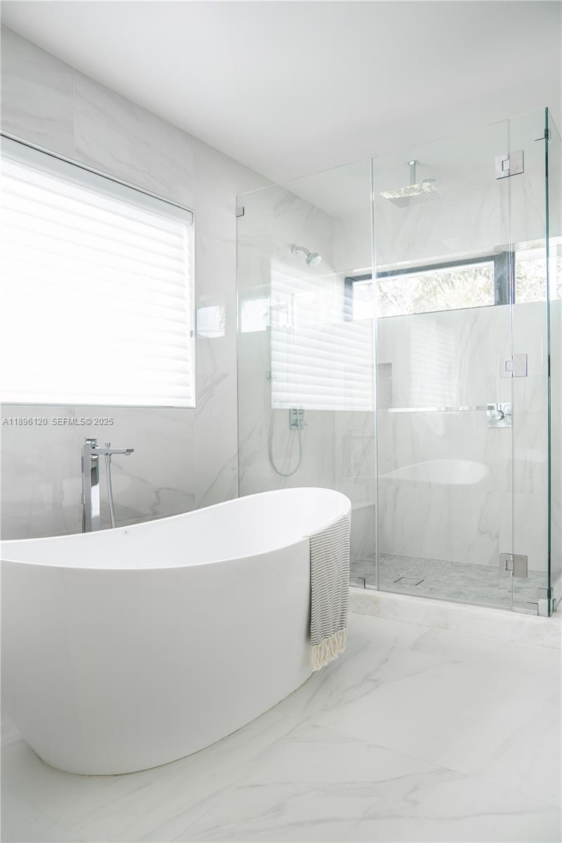 12855 Maple Road North Miami, FL 33181 - Photo 28 of 51 a white bath tub sitting in a bathroom