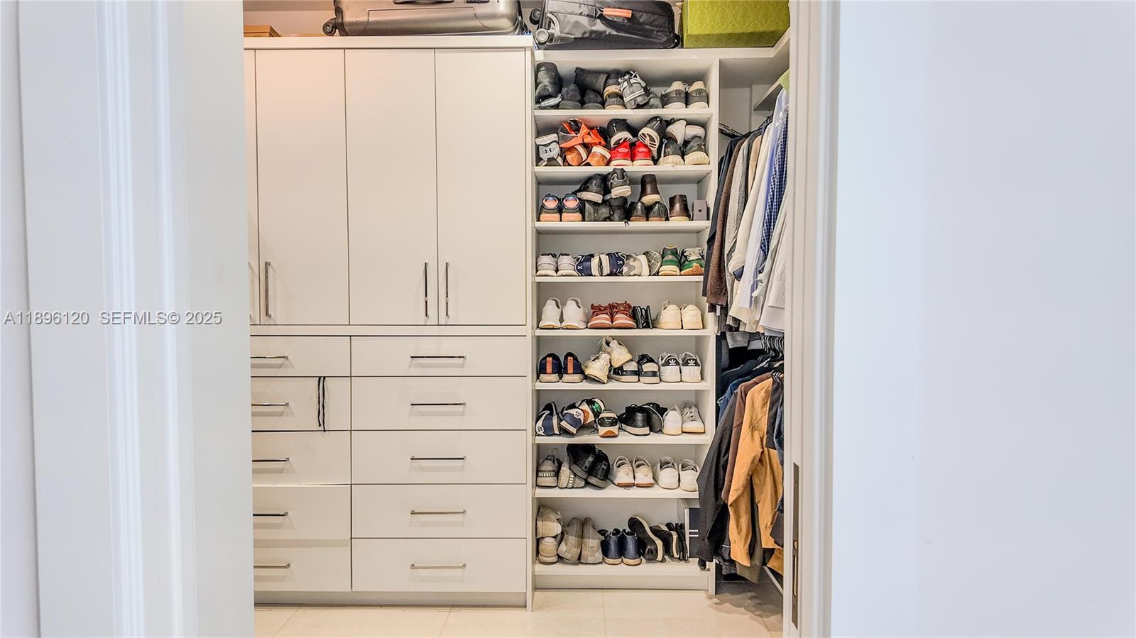 12855 Maple Road North Miami, FL 33181 - Photo 30 of 51 a view of walk in closet with clothes and shoes