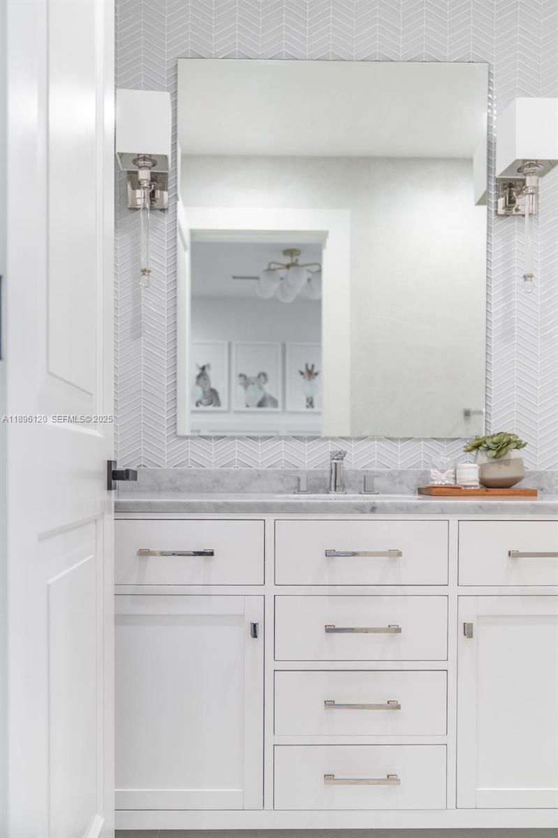 12855 Maple Road North Miami, FL 33181 - Photo 32 of 51 a bathroom with a sink vanity and mirror