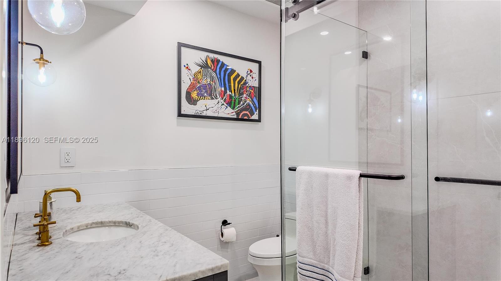 12855 Maple Road North Miami, FL 33181 - Photo 39 of 51 a bathroom with a granite countertop sink a toilet and shower