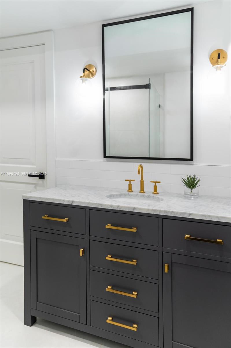 12855 Maple Road North Miami, FL 33181 - Photo 40 of 51 a bathroom with a sink vanity and mirror